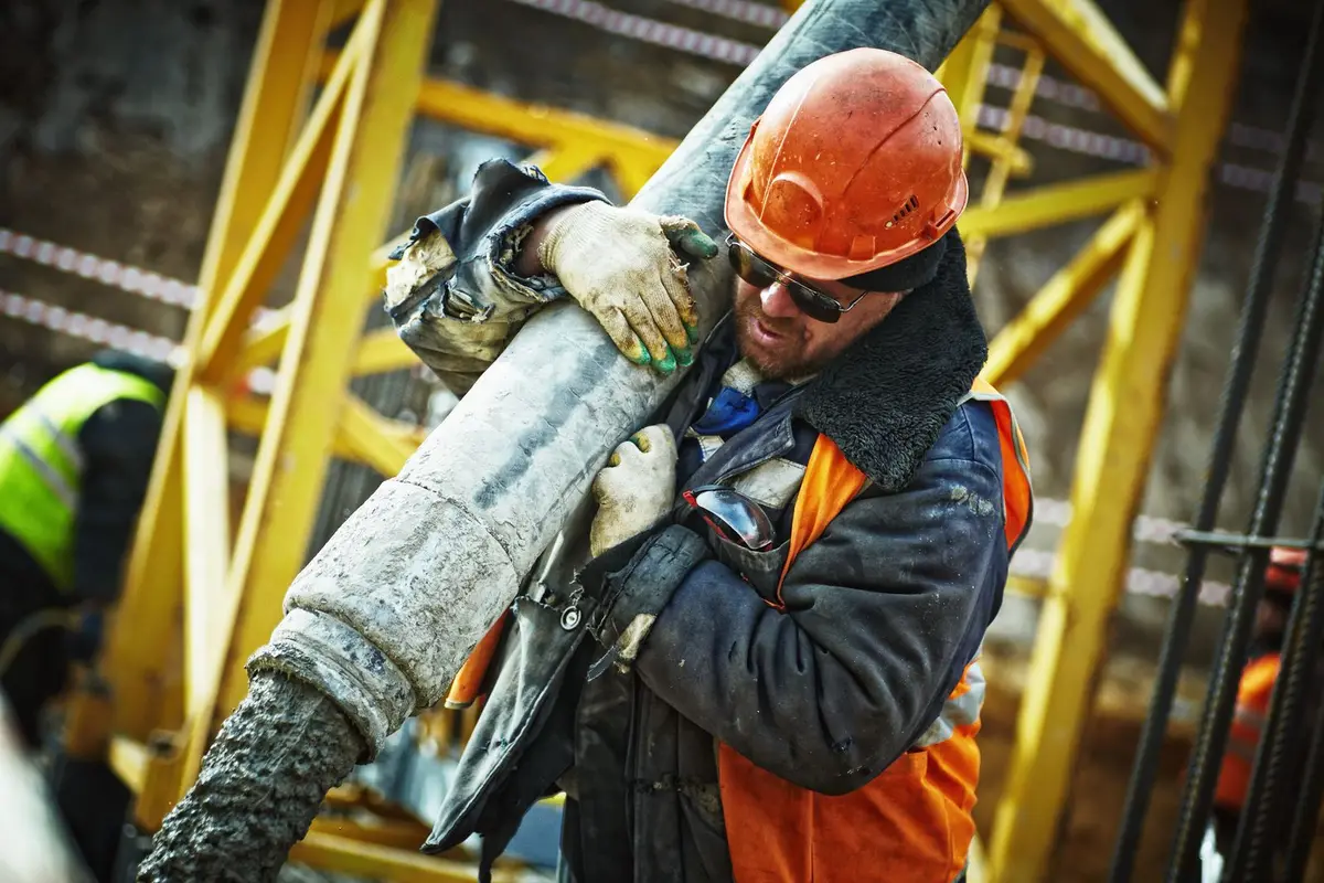 A construction worker in a hard hat on a building site.