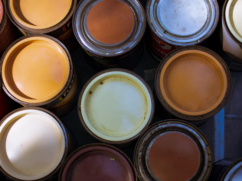 Open paint tins in a range of colours