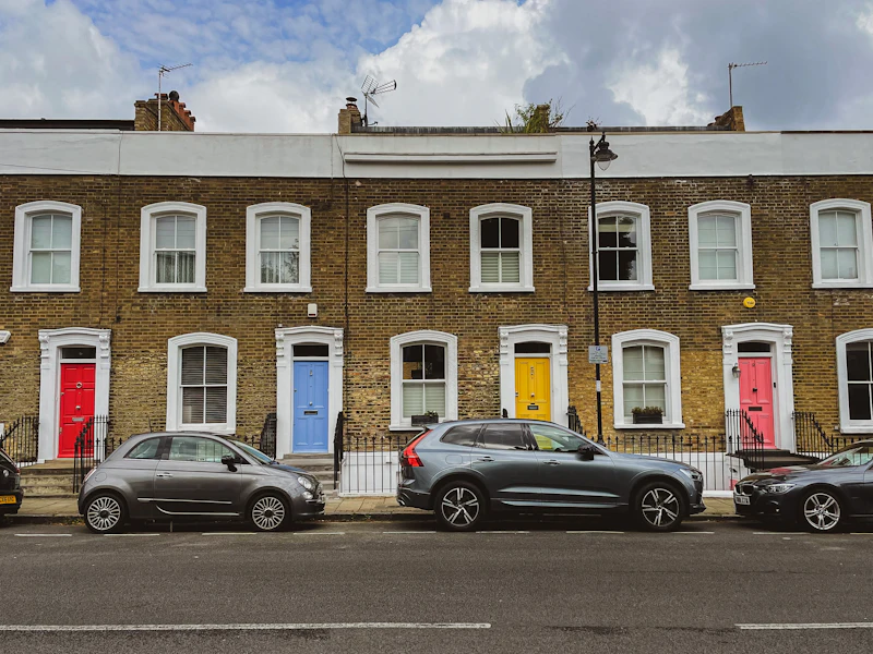 Brick terrace with brightly painted front doors