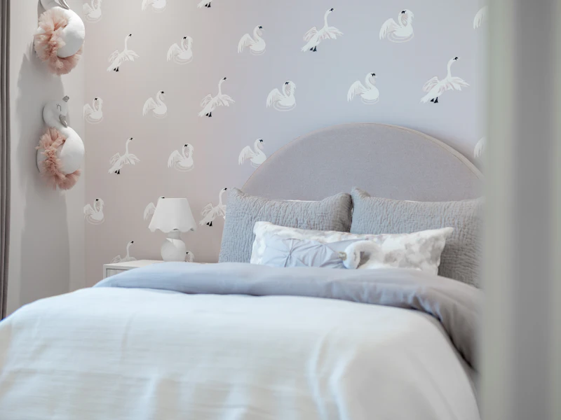 Bedroom with patterned wallpaper behind the bed
